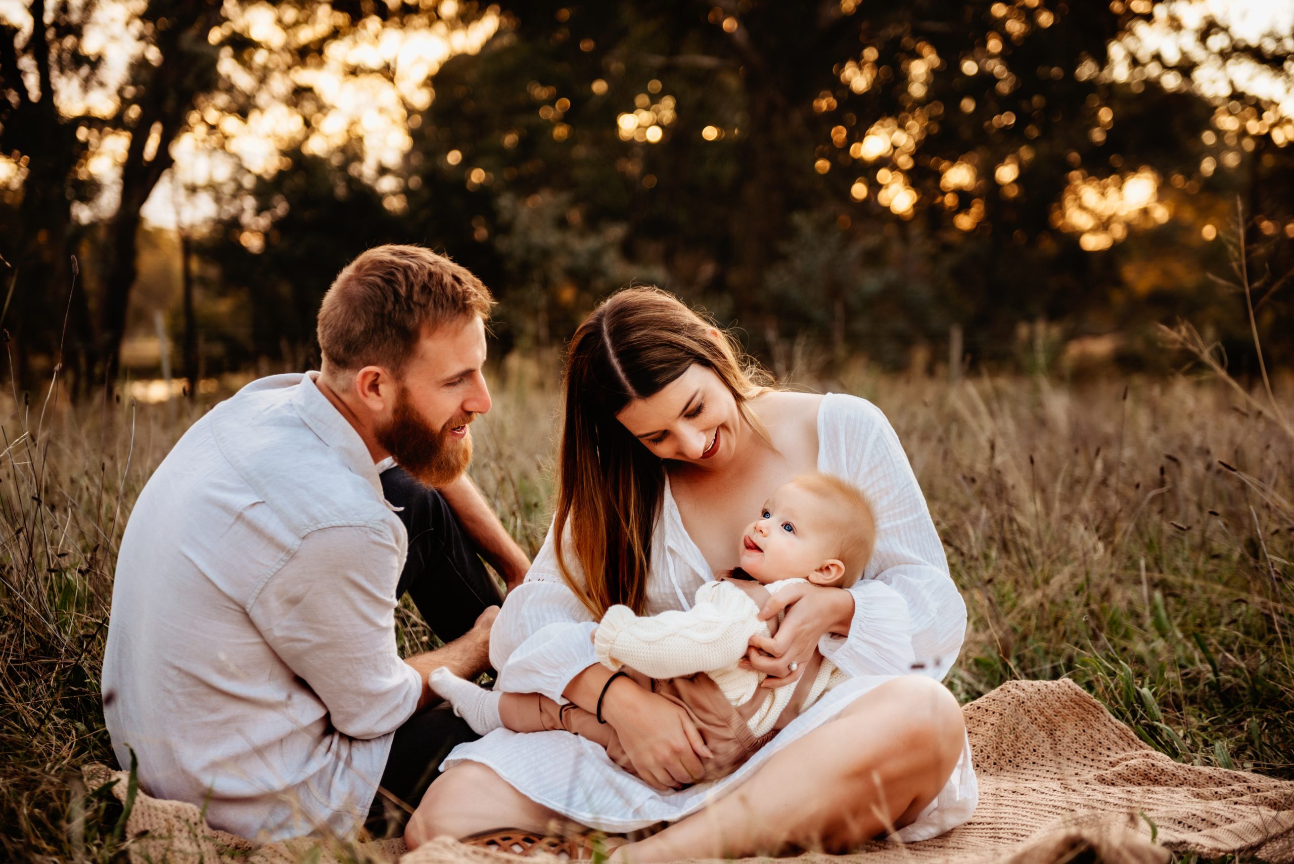 family-banner canberra family photographer family cuddling in the grass